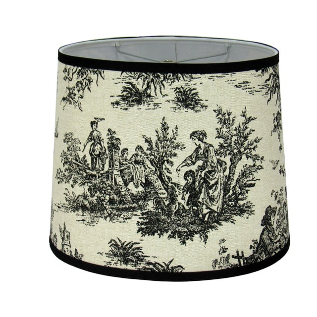 This black and off-white oval toile lamp shade features a timeless pastoral design, blending classic elegance with a...