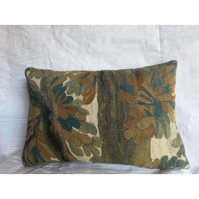 This 17th century Brussels tapestry pillow features a balanced botanical composition centered around a vertical axis,...