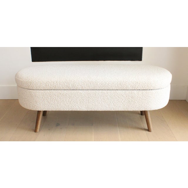 Oval Ottoman Storage Bench. Restyled with custom upholstery in neutral bounce fabric, adding texture and sophistication....