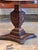 A round rose-veined marble top on a grained faux rosewood pedestal — the dark streaking is well executed and gives the...