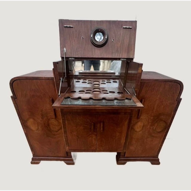 An exceptional 1920s Art Deco bar cabinet showcasing the elegance and craftsmanship of the Jazz Age. Crafted from richly...