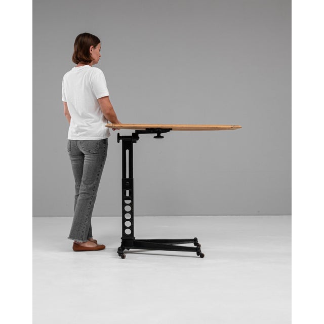 This 1920s French folding table is a masterful blend of industrial design and rustic charm, making it both functional and...