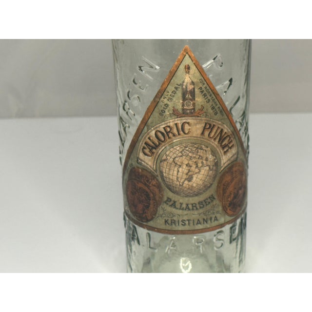 Rare 19th Century P. A. Larsen Caloric Punch Bottle with Original Label for your consideration. The bottle measures...
