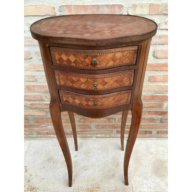 A rare pair of beautiful round nightstands that have a top, sides, back and an inlaid marquetry front panel, with three...