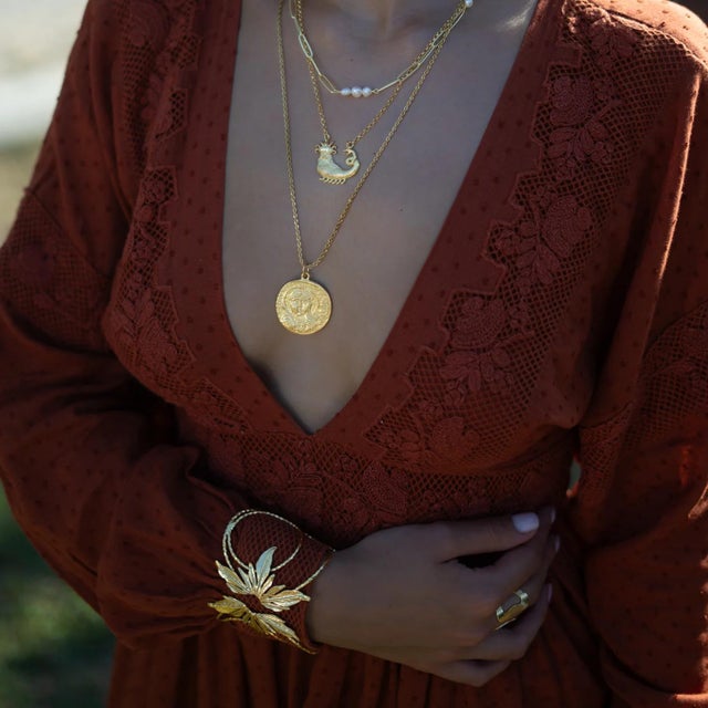 Embrace the beauty of nature with the Floral Spirit Gold Arm & Cuff Bracelet. Handcrafted from bronze and plated with...