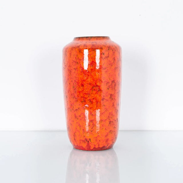 Tinted with hints of earthy green, this red vase has color from another world. Our vases have been carefully curated from...