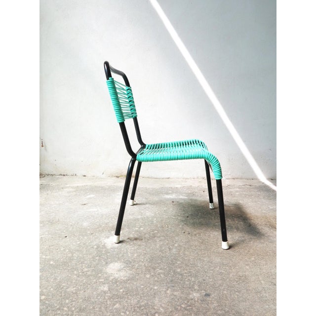 Original 70s chair for children with aquamarine green pvc laces and black painted metal tubular chair. Suitable for indoor...
