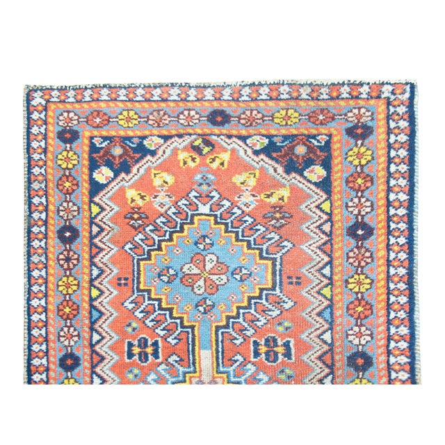 A wonderful early 20th century Persian Heriz runner with five large medallions, each with a stylized floral pattern,...