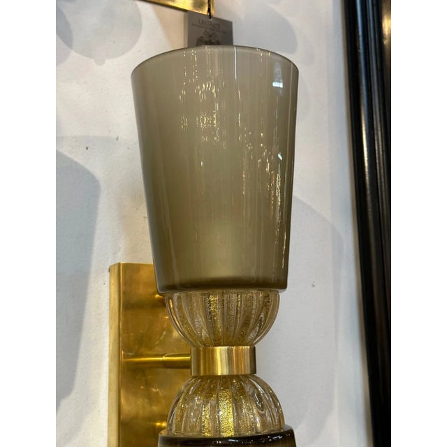 Stylish pair of modern Murano glass and brass double cones sconces. Featuring beautiful grayish/green and gold glass on...