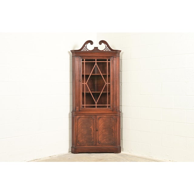 A gorgeous Georgian or Chippendale style corner bar cabinet, dining cabinet, or display cabinet In the manner of Baker...