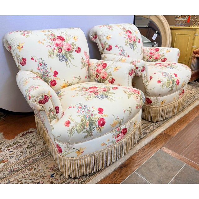 An exceptionally charming pair of custom club chairs upholstered in iconic Scalamandré floral chintz, showcasing a lush...