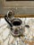 Beautiful small silver plated teapot with a lot of character. - small ivory top with a black wooden handle. Bottom has a...