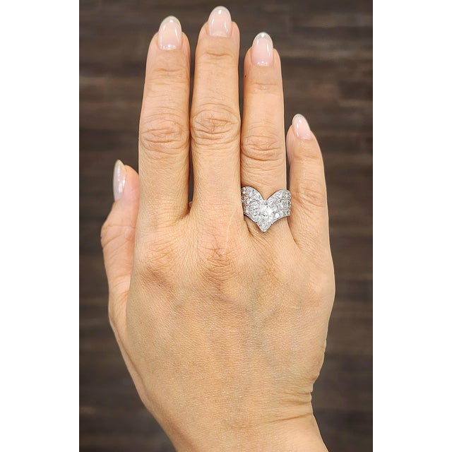 A captivating ring showcasing a unique V-shaped design. The centerpiece is an approximately 1.60-carat natural marquise-...