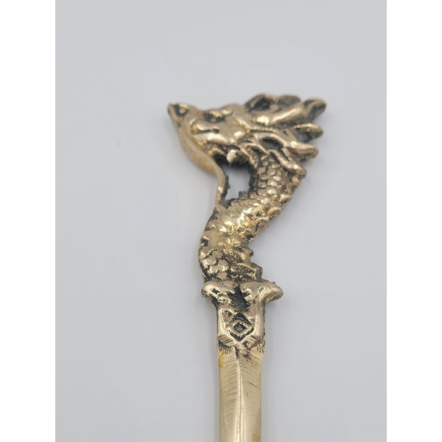 A striking vintage desk accessory, this solid brass letter opener features an intricately cast dragon that serves as the...