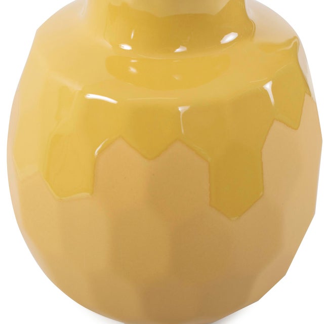 A stunning piece from our collection featuring a honeycomb-designed texture. With its rich golden yellow color, this vase...