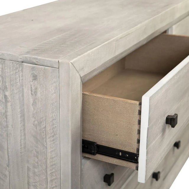 Light grey wash finish acacia wood dresser with six drawers. Modern black square metal knobs. Each may vary slightly in...