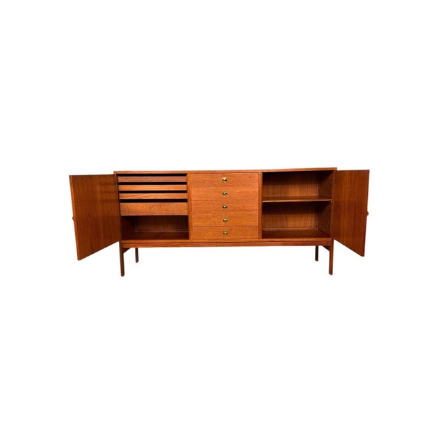 This teak sideboard was designed by Ole Gjerlov Knudsen and Torben Lind for France & Sons and is a strong example of clean...