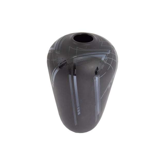 A 1989 art glass vase by the American glass artist Bob Toensing. Made of black glass, this vase features a geometric...