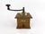A charming early 20th-century French manual coffee grinder by Peugeot Frères, featuring a traditional wooden box, a brass-...