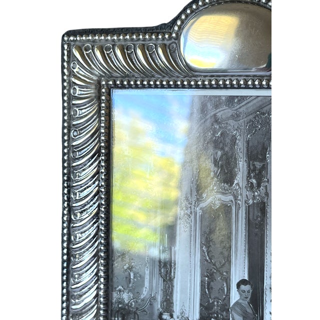 A beautifully crafted Italian sterling silver picture frame, richly detailed with a classic beaded and fluted border and a...