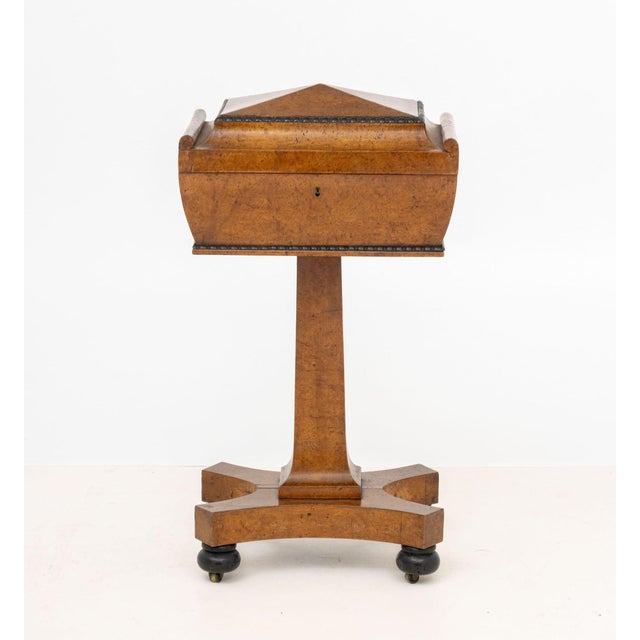 English Regency Burr Elm Teapoy Stand, 19th century, the top opening to four tea compartments centering a central...