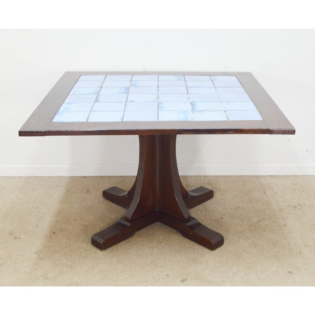 Dining Table by Stickley. Store item #542. It features solid oak wood and tile top.