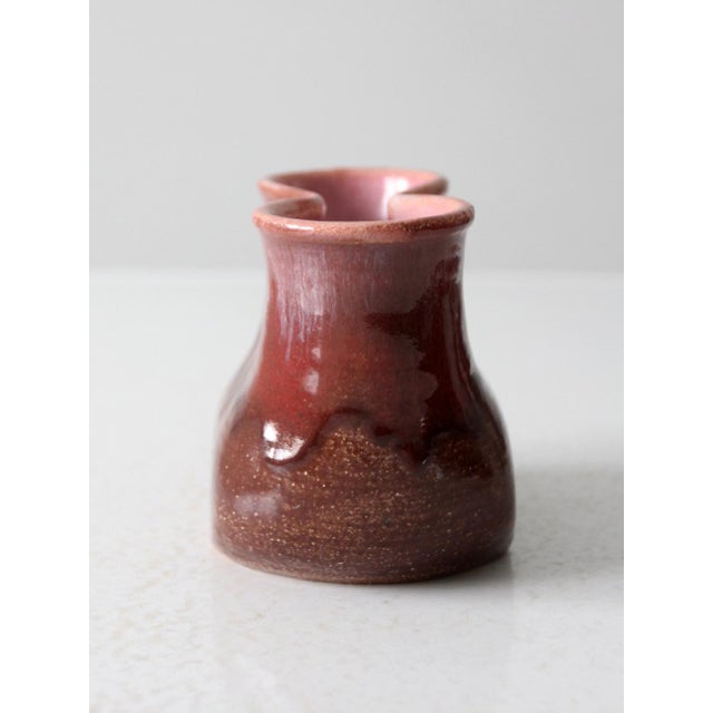 This vintage handmade pottery vase features a distinctive double-opening design, making a striking statement piece for any...