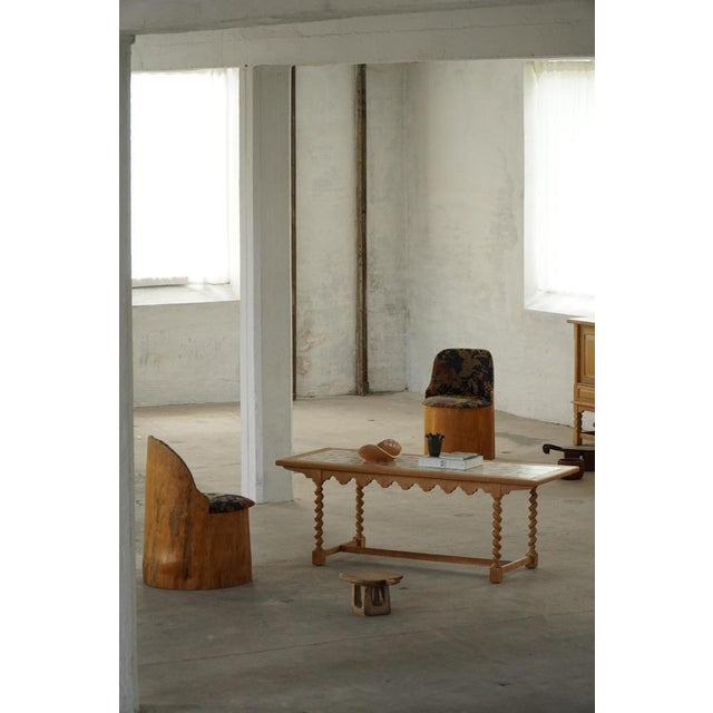 A beautiful Danish coffee table crafted in solid oak and produced in Denmark during the 1960s. The table features an...