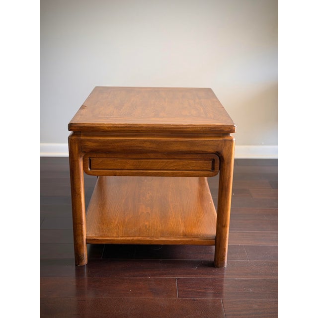 A handsome vintage Asian Modern end table or nightstand executed in richly grained teak finish with a clean architectural...