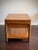 A handsome vintage Asian Modern end table or nightstand executed in richly grained teak finish with a clean architectural...