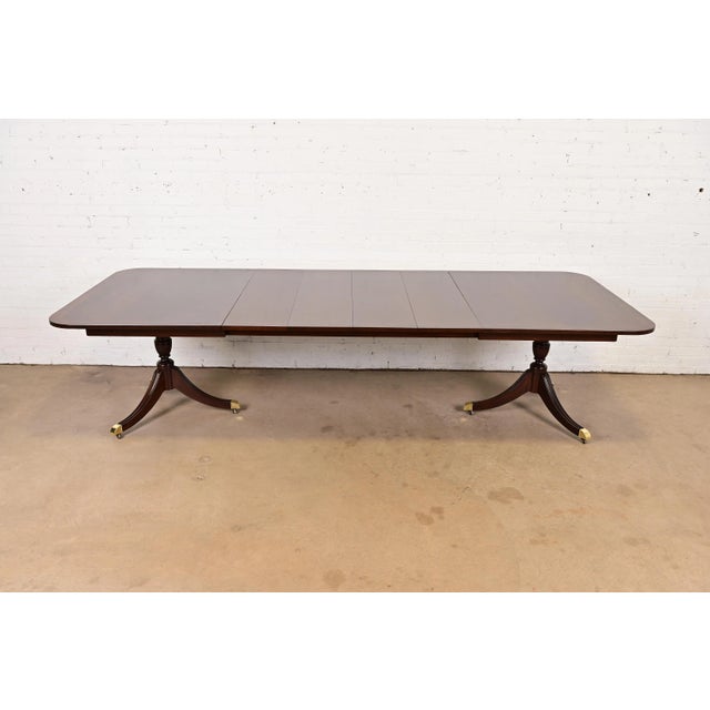 A gorgeous Georgian or Regency style double pedestal extension dining table By Kindel Furniture USA, Circa 1980s Banded...