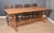 Large Oak refectory table, the plank top, raised on trestle ends united by wavey stretcher. Dimensions Height 30 Inches...