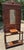 Lovely antique carved wood hall tree featuring glove box, 6 brass hooks, center mirror, two umbrella or cane stands with...