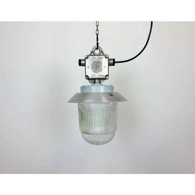 This Industrial hanging light was made by Elektrosvit in former Czechoslovakia during the 1970s. It features a cast...