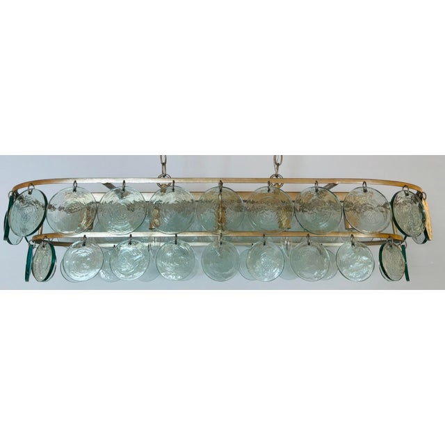 Original Retail $2390, stylish Currey & Company Modern Glass Disc Settat Chandelier, warm silver leaf finished frame,...