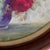 Bring classic mid-century elegance to your home with this vintage circular floral still life print. This piece features a...