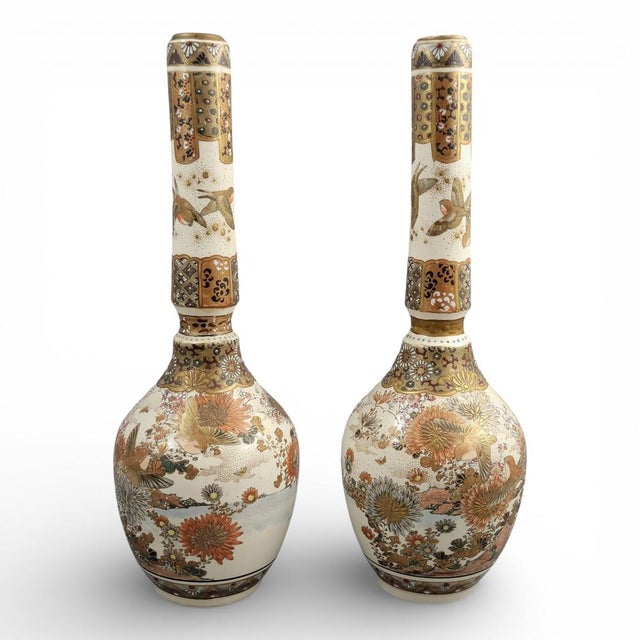 An outstanding pair of tall Japanese Satsuma vases from the Meiji period, distinguished by their elegant elongated bottle...
