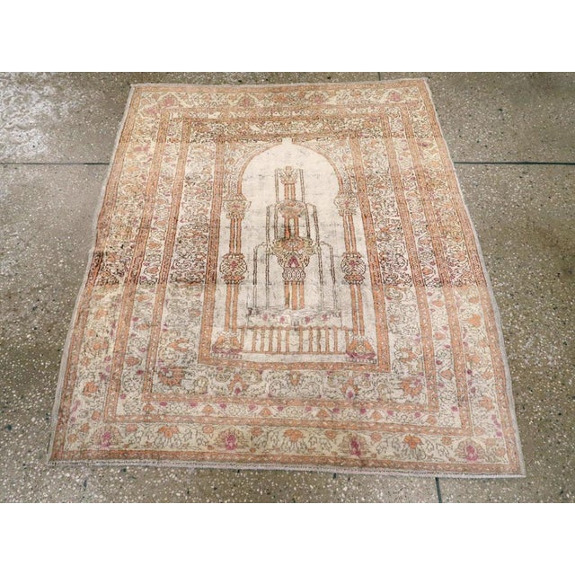 This Mid-20th century Turkish Sivas rug, measuring 3' 2" x 3' 7", showcases a finely drawn prayer design imbued with the...