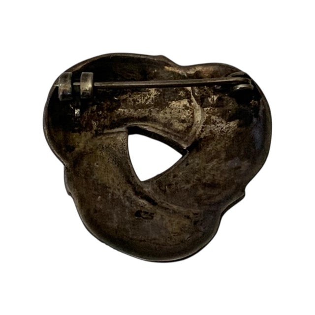 This is a vintage 925 sterling silver marcasite twist brooch pin. It features a triple knot or abstract twist design...