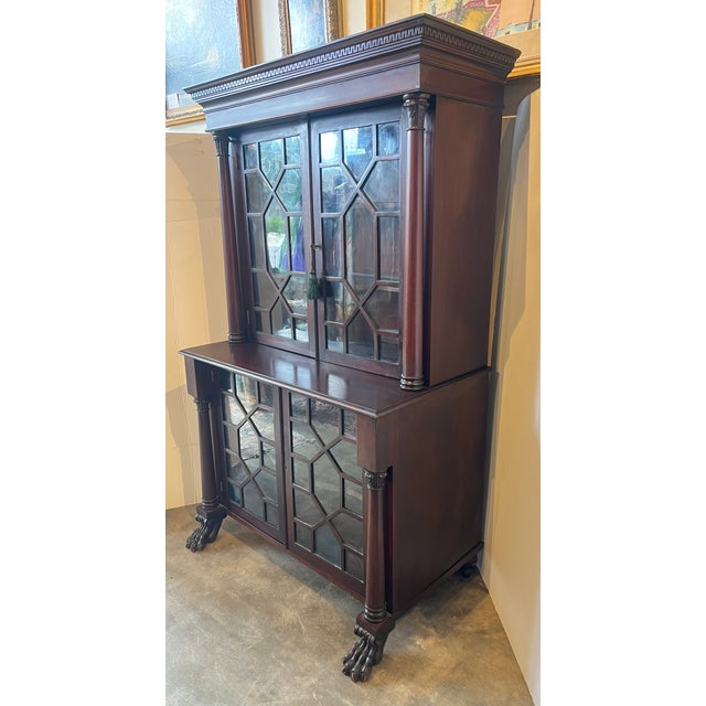 Beautiful Turn of the Century American Empire Mahogany Step Back Bookcase. It features a two-part design common to Empire...