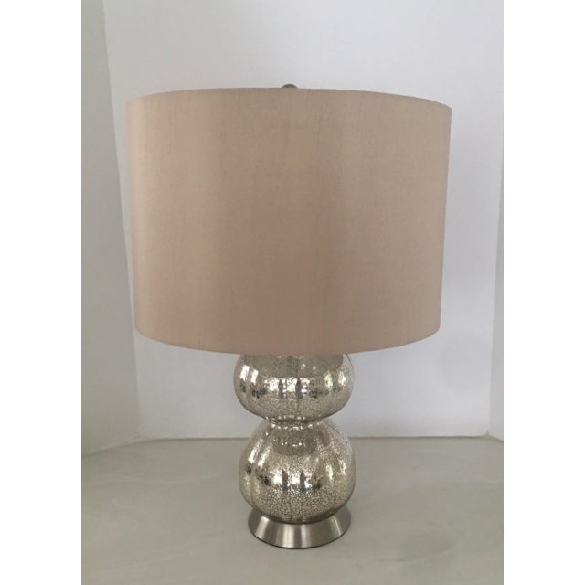 New mercury glass lamp with tan linen shade. Purchased for a. Model , never used. Measures 6”x 6” x 22.5”. Measures 16” to...