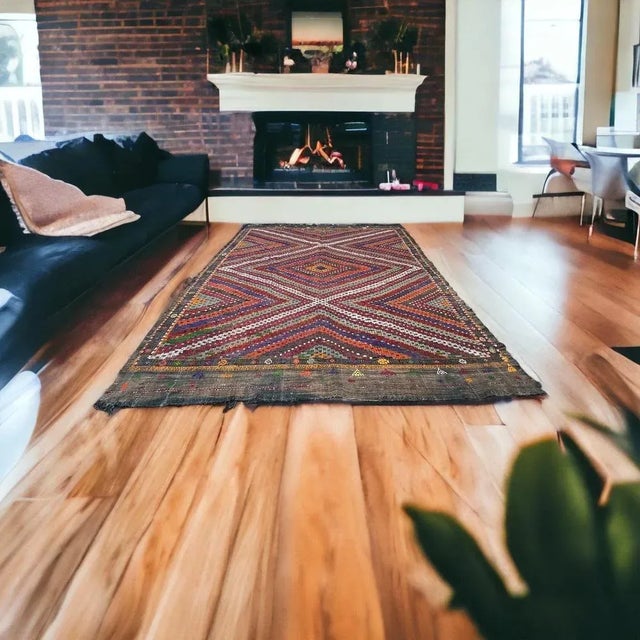 This traditional Turkish kilim rug, also known as a vintage Anatolian Turkish kilim, is a stunning piece measuring 295 by...