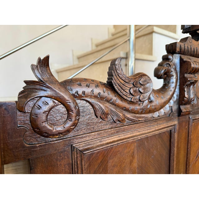 An Exquisite antique French Louis XVI full size bed. Made of Walnut, featuring foliate carved ribbon and crest with center...