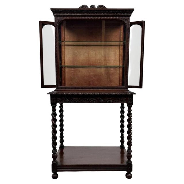 An exceptional 19th-century English display cabinet, finely crafted from oak and distinguished by its intricate carved...