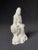 A charming porcelain figure of seated Guanyin, goddess of compassion and mercy. Seated on a limestone plinth with the...