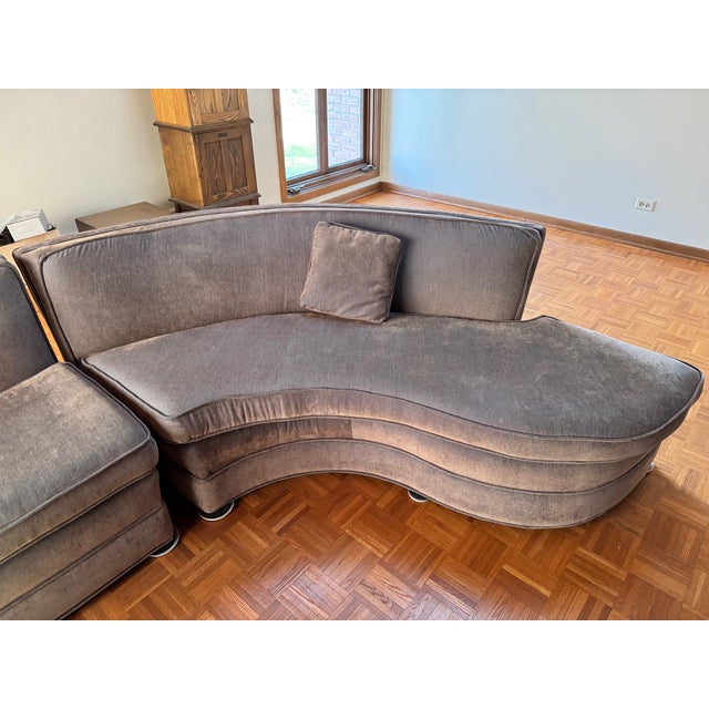 This two piece sectional Serpentine couch reminiscent of Vladmir Kagam style set on casters. The sofa is a muted brownish-...
