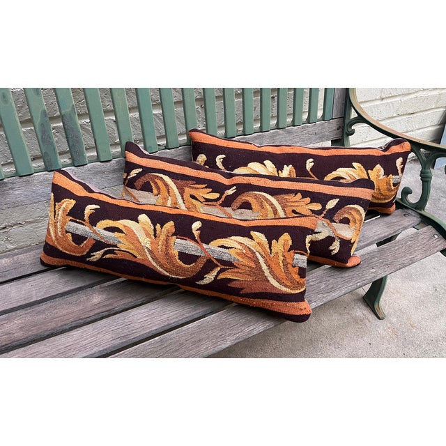 This beautiful set of three decorative pillows is upholstered in antique tapestry featuring warm orange and gold tones....