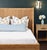 Introducing the Dolly Headboard - a winged headboard and platform, crafted from radio weave wrapped rattan. This unique...
