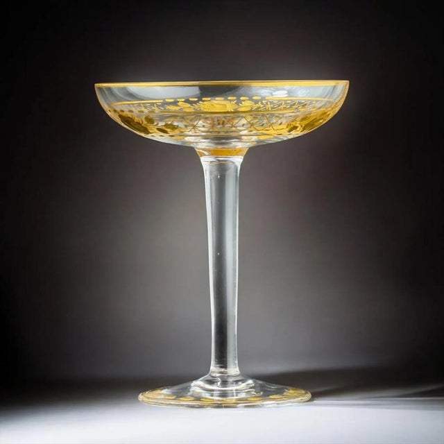 Elegant antique decorative goblet dating to the late 19th century, crafted from fine clear glass and richly decorated with...
