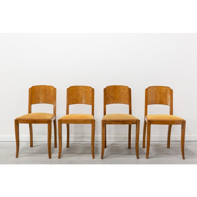 Set of four chairs made of birch wood, in Art Deco style and period. Crafted in honey-toned birch burl, they feature a...